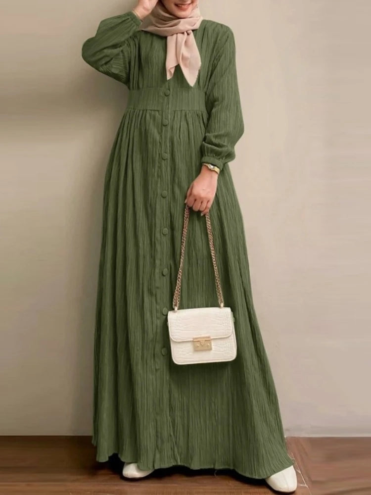 Robe longue Selma vert — profil, manches bouffantes resserrées aux poignets